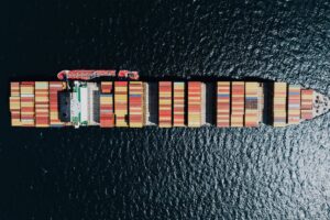 directly above a fully loaded cargo ship on a sea